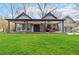 Gray craftsman style home with a large front porch and nicely landscaped lawn at 4900 Lilburn Stone Mountain Sw Rd, Lilburn, GA 30047