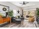 Spacious living room featuring a comfortable sectional sofa and large windows at 4900 Lilburn Stone Mountain Sw Rd, Lilburn, GA 30047