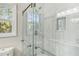 Large walk-in shower with marble-tiled walls and a frameless glass enclosure at 4597 Dahlia Dr, Pine Lake, GA 30072