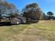 Large backyard with detached shed and mature trees at 6820 Highway 20, Loganville, GA 30052