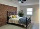 Bedroom with brick feature wall and ceiling fan at 6820 Highway 20, Loganville, GA 30052