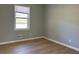 Simple bedroom with hardwood floors and window at 6820 Highway 20, Loganville, GA 30052