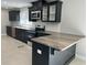 Modern kitchen with dark cabinetry, granite countertops, and stainless steel appliances at 6820 Highway 20, Loganville, GA 30052