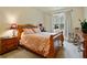 Bright bedroom with a comfortable queen-size bed and wood furniture at 3050 Pleasant Valley Trl, Cumming, GA 30028