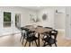 Modern dining room with wooden table and black chairs, access to deck at 1980 Oakdale Se Ct, Smyrna, GA 30082