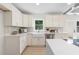 Modern kitchen with white cabinets, quartz countertops and farmhouse sink at 1980 Oakdale Se Ct, Smyrna, GA 30082