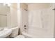 Clean, white bathroom with tub/shower combination and built-in shelving at 3900 Emerald North Dr, Decatur, GA 30035