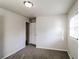 Bright, open bedroom with neutral walls, carpeting, and a door leading to another room at 3900 Emerald North Dr, Decatur, GA 30035