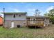 Rear exterior view of the home showing a deck, backyard, and AC unit at 3900 Emerald North Dr, Decatur, GA 30035