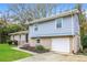 Charming two-story home with a one-car garage and landscaped front yard at 3900 Emerald North Dr, Decatur, GA 30035