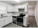 Updated kitchen featuring white shaker cabinets, stainless steel appliances, and wood-style flooring at 3900 Emerald North Dr, Decatur, GA 30035