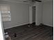 Small bedroom with gray walls and dark gray vinyl flooring at 4922 Rock Springs Rd, Lithonia, GA 30038