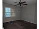 Simple carpeted bedroom with a window and ceiling fan at 4922 Rock Springs Rd, Lithonia, GA 30038