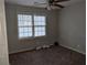 Small bedroom with gray walls, ceiling fan and dark brown carpet at 4922 Rock Springs Rd, Lithonia, GA 30038