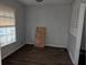 Empty dining room with gray walls and dark brown vinyl flooring at 4922 Rock Springs Rd, Lithonia, GA 30038