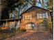 Two-story house with wood siding, brick base, and a covered porch at 4922 Rock Springs Rd, Lithonia, GA 30038