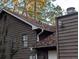 House exterior showing brown siding, roof with leaves, and downspouts at 4922 Rock Springs Rd, Lithonia, GA 30038