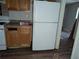 Kitchen area with white appliances and wood cabinets at 4922 Rock Springs Rd, Lithonia, GA 30038