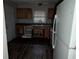 Simple kitchen with wood cabinets, appliances, and vinyl flooring at 4922 Rock Springs Rd, Lithonia, GA 30038