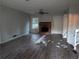 Living room with brick fireplace and debris on the floor at 4922 Rock Springs Rd, Lithonia, GA 30038