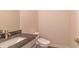 Small bathroom with granite countertop, sink, and modern toilet at 189 Orwell Dr, Social Circle, GA 30025