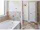 Spa-like bathroom with soaking tub and tile flooring at 318 Emporia Loop, Mcdonough, GA 30253
