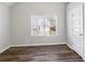 Bright bedroom featuring hardwood floors and a window at 318 Emporia Loop, Mcdonough, GA 30253