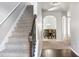 Bright entryway with hardwood floors, staircase, and views into the dining room at 318 Emporia Loop, Mcdonough, GA 30253