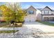 Two-story house with a two-car garage and a landscaped lawn at 318 Emporia Loop, Mcdonough, GA 30253