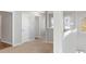 Upstairs hallway with carpet, neutral walls and multiple doors to bedrooms at 318 Emporia Loop, Mcdonough, GA 30253
