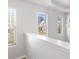 Upstairs hallway with windows, neutral walls, and a view of the neighborhood at 318 Emporia Loop, Mcdonough, GA 30253