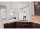 Open kitchen with granite island, double sinks, and views into the living room at 318 Emporia Loop, Mcdonough, GA 30253