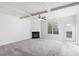 Spacious living room with fireplace, carpet, and access to backyard patio at 318 Emporia Loop, Mcdonough, GA 30253