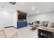 Finished basement with a TV, sectional sofa, and built-in entertainment center at 7802 Bamby Rd, Cumming, GA 30041