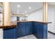 Dark blue cabinets and a live-edge wood countertop highlight this basement bar at 7802 Bamby Rd, Cumming, GA 30041