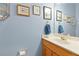 Small powder room with light blue walls at 7802 Bamby Rd, Cumming, GA 30041