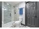 Modern bathroom with a glass shower, patterned tile floor and dark vanity at 7802 Bamby Rd, Cumming, GA 30041