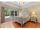 Bright bedroom with hardwood floors, large windows and a ceiling fan at 7802 Bamby Rd, Cumming, GA 30041
