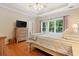 Spacious primary bedroom with wood floors and large windows at 7802 Bamby Rd, Cumming, GA 30041