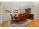 Bright dining room with hardwood floors, chandelier, and antique furniture at 7802 Bamby Rd, Cumming, GA 30041