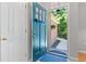 Inviting entryway with a teal door and wood flooring at 7802 Bamby Rd, Cumming, GA 30041