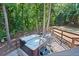 Relaxing hot tub on a deck overlooking a wooded backyard at 7802 Bamby Rd, Cumming, GA 30041