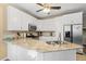 Modern kitchen with white cabinets, granite countertops, and stainless steel appliances at 7802 Bamby Rd, Cumming, GA 30041