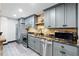 Modern gray kitchen with stainless steel appliances and granite countertops at 7802 Bamby Rd, Cumming, GA 30041