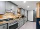 Modern gray kitchen with stainless steel appliances and granite countertops at 7802 Bamby Rd, Cumming, GA 30041