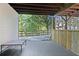 Covered patio with wood plank walls and wooded views at 7802 Bamby Rd, Cumming, GA 30041