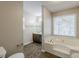 Bathroom with soaking tub, vanity, and window at 271 Kings Walk, Douglasville, GA 30134