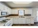 White kitchen with wood-look flooring, white cabinets, and stainless steel appliances at 271 Kings Walk, Douglasville, GA 30134