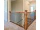 Upstairs hallway with wooden railing and carpet flooring at 9183 Golfview Cir, Covington, GA 30014