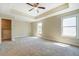 Large main bedroom with high ceilings, two windows, and a walk-in closet at 9183 Golfview Cir, Covington, GA 30014